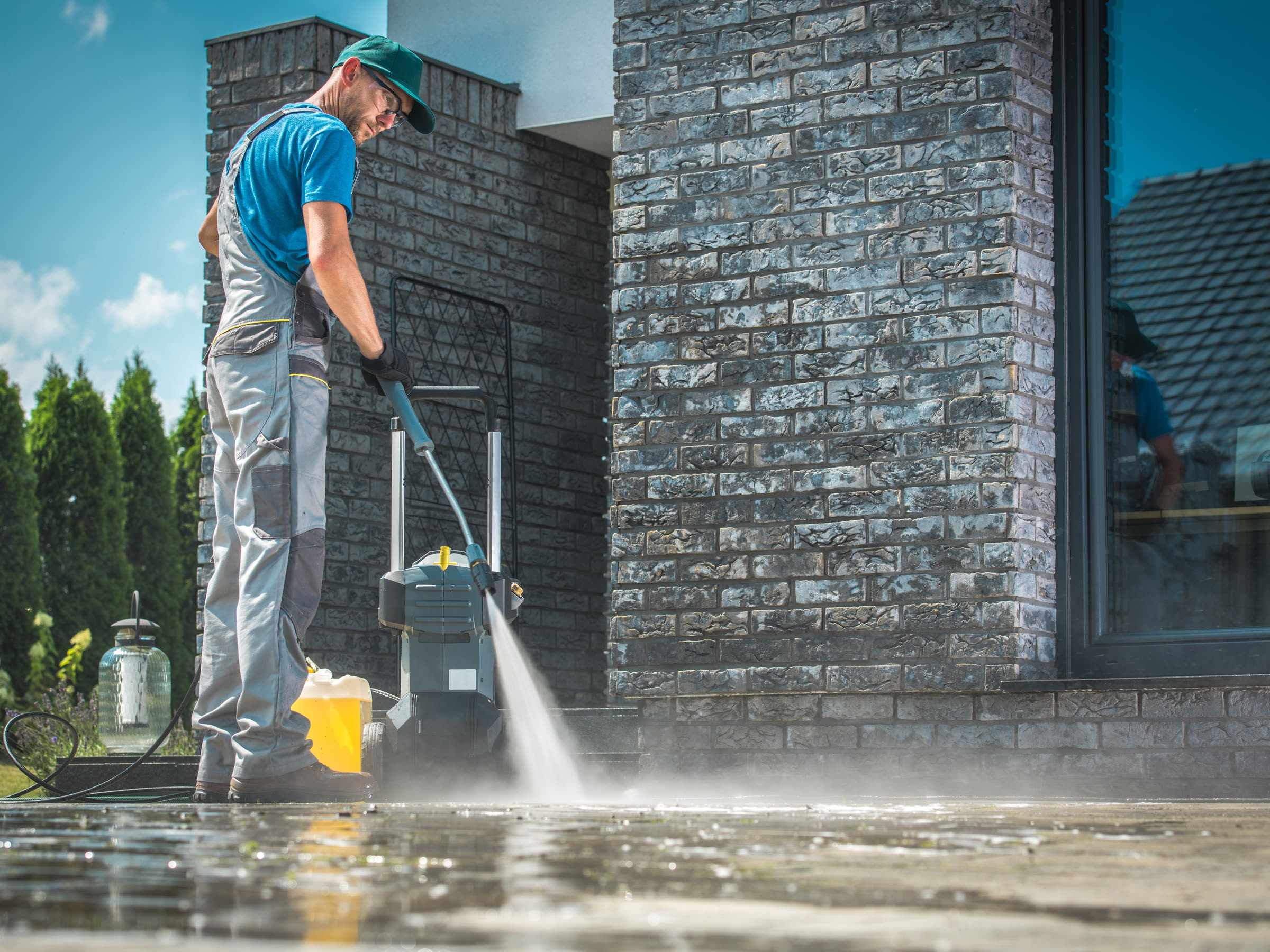 Pressure washing a stone patio